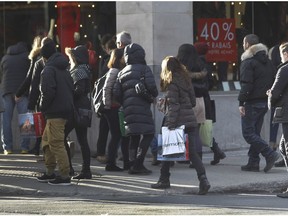 Christmas shoppers walk on Ste-Catherine St. on Saturday, Dec. 19, 2015, in Montreal on this last weekend before Christmas.(Marie-France Coallier / Montreal Gazette)