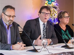 Left to right: FTQ President Daniel Boyer, CSN President Jacques Letourneau, and President of the SFPQ and representative of SISP, Lucie Martineau, right, speak to the media during a press conference to talk about the details of this week's agreement between Front Commun union group and the government of Quebec in Montreal on Sunday, Dec. 20, 2015.