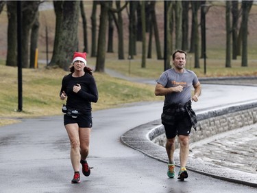 Danie Labonville, left, and Yves Blanchard jog in Mount Royal Park in Montreal on Thursday December 24, 2015.