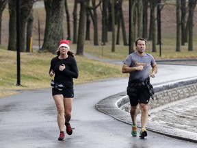 Danie Labonville and Yves Blanchard jog in Mount Royal Park in Montreal on Thursday December 24, 2015. Josh Freed urges Montrealers to seize the warm weather while it lasts.