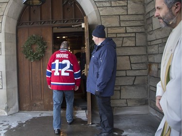 MONTREAL, QUE.: DECEMBER 28, 2015 -- A mourner arrives wearing a Moore jersey at Mountainside United Church for the funeral of Hab legend Dickie Moore in Montreal, Monday December 28, 2015.  (Vincenzo D'Alto / Montreal Gazette)