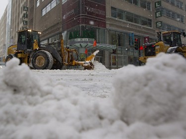 Snow removal crews plow Robert Bourassa Boulevard at de Maisonneuve in Montreal on Tuesday December 29, 2015. Montreal received its first major snow fall after a very warm start to the winter.