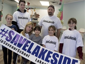 Jennifer Park, 2nd from left, and her family sit in the playroom of Park Place Daycare, where she is the director,  in Dorval on Wednesday Dec. 30, 2015. Park is leading a campaign to save Lakeside Academy, the last English high school in Lachine and Dorval. Sammy De Luca,10, left to right, Leila De Luca, 5, Chase De Luca, 6, Jayme de Luca, 12, Shane De Luca, back row left, and Park's husband Jonathan Deluca show their support for her campaign to save the school.