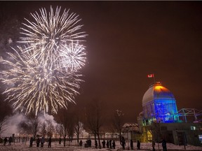 Fireworks light up the sky over the Bonsecours Basin outdoor skating rink in the old port of Montreal during New Years eve fireworks display to ring in the new year Tuesday, December 31, 2013.