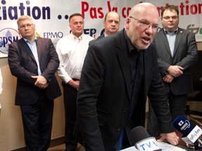 Marc Ranger, Quebec director of the Canadian Union of Public Employees, speaks at a press conference in Montreal at FTQ offices in Montreal Thursday, December 4, 2014.