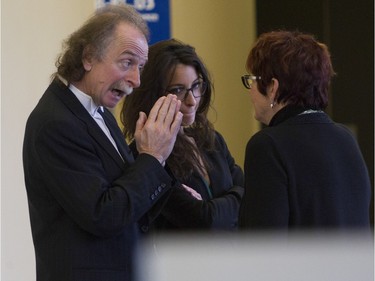 Guy Poupart (left), with a member of the legal team for Guy Turcotte, speaks with a woman in a St. Jérôme courtroom before the verdict iis delivered on Sunday, Dec.r 6, 2015.