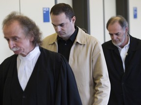 Guy Turcotte (centre) walks between one of his lawyers Guy Poupart (left) and his father Réal Turcotte towards a St. Jérôme courtroom to hear his verdict in his double murder trial in St Jérôme north of Montreal on the seventh day of deliberation by the jury Sunday, December 6, 2015. He was found guilty of 2 counts of second degree murder for killing his two children in 2009.