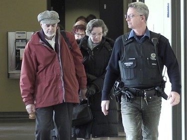 Guy Turcotte's parents Marguerite Fournier and Réal Turcotte are escorted from the St. Jérôme courthouse after their son, Guy Turcotte, was convicted of second-degree murder Sunday, Dec. 6, 2015, in St Jérôme north of Montreal.