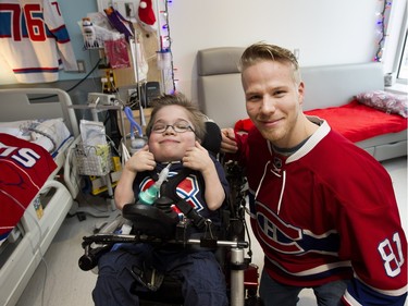 Eleven year old Loic Bydal gives the thumbs up as he is photographed with Montreal Canadiens Lars Eller during a team visit at the Montreal Children's Hospital in Montreal on Tuesday December 8, 2015.