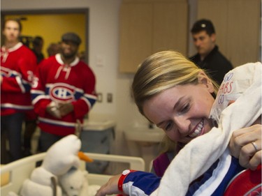 Geneviève Verret rushes to get her son, Maxence Gosselin ready as the Montreal Canadiens enter his room as they visit the Montreal Children's Hospital in Montreal on Tuesday December 8, 2015.
