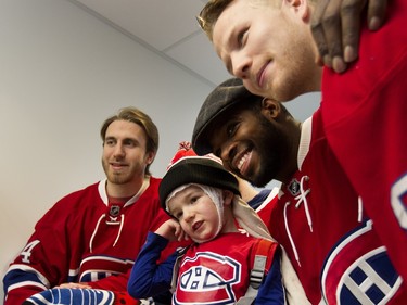 Maxence Gosselin, 4, gets a little shy as P.K. Subban holds him for a picture during the Montreal Canadiens visit at the Montreal Children's Hospital in Montreal on Tuesday December 8, 2015. Jarred Tinordi, left, and Lars Eller also pose for pictures with Gosselin.