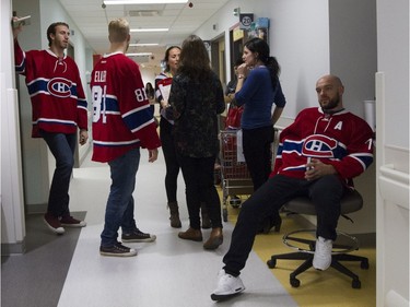 Montreal Canadiens Andrei Markov, right, waits outside a patient's room with the team as the team visits the Montreal Children's Hospital in Montreal on Tuesday December 8, 2015.