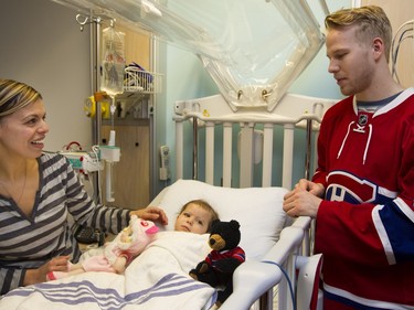 Montreal Canadiens Lars Eller listens as Theresa Roumi, left, tells him about her daughter Mariella Roumi's condition during a team visit to the Montreal Children's Hospital in Montreal on Tuesday December 8, 2015.