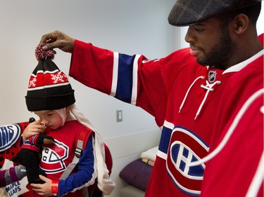 Montreal Canadiens P.K. Subban tugs on Maxence Gosselin's hat as the teams visits the Montreal Children's Hospital in Montreal on Tuesday December 8, 2015.