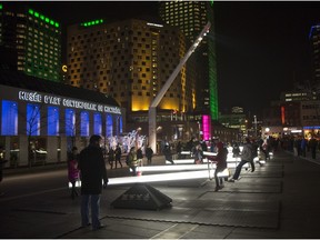 Montrealers enjoy seesaws at an installation titled Impulse at Place des Spectacles in Montreal, Wednesday December 9, 2015.
