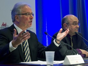 File photo: Dr. Charles Bernard, president of Quebec's College of Physicians, speaking at a press conference with Dr. Yves Robert, right, secretary for the College, in Montreal, Tuesday Feb. 3, 2015.