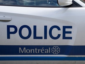 MONTREAL, QUE.: JULY 16, 2014-- A Montreal police car that has been tagged with union stickers protesting proposed changes to the pension funds is parked on de L' Eglise street outside station 15 in Montreal on Wednesday July 16, 2014.  (Allen McInnis / THE GAZETTE)  ORG XMIT: 50470