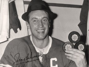 Jean Béliveau celebrates one of his 18 career three-goal hat tricks in the Habs dressing room in the Forum during the 1960s, wearing the fedora of coach Hector (Toe) Blake.