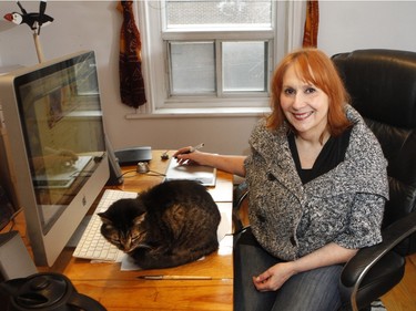 Graphic artist Jennifer Cook and her cat Sparky in her office. (Marie-France Coallier / MONTREAL GAZETTE)
