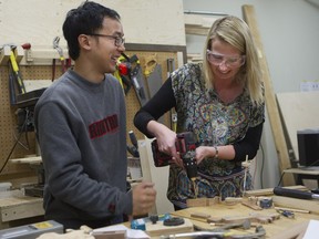 Ernest Fung shows student Valerie Fréchette how to make a wooden toy for Christmas at La Remise, a tool library in Villeray that offers its members tools from its catalogue, plus work space and classes.