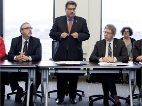 File photo: Montreal Mayor Denis Coderre convenes a special meeting that includes a wide range of emergency service personal and military staff from the Royal 22nd Regiment, The Van Doos, in Montreal on Thursday Nov. 19, 2015. Michel Dorais sits next to Coderre. Dorais was hired as a special consultant at $1800 per day to coordinate the city's efforts to welcome Syrian refugees.