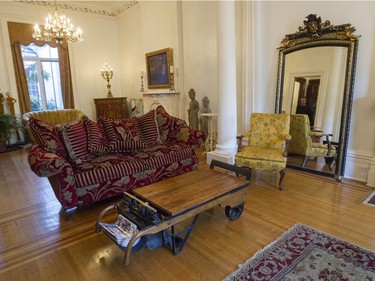 A view of the living room, which includes a weigh scale from the early 20th century, serving as a coffee table.