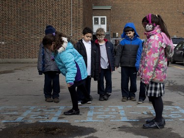 Harout Hamalian, 8, second from right, learns to play hopscotch with his classmates during a recess break at Sourp Hagop school in Montreal on Thursday November 26, 2015.
