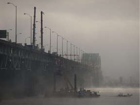 Cranes wait in the fog to lift the super beam that will re-enforce Champlain Bridge in 2013.