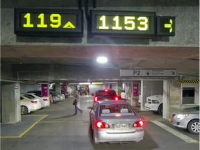 File photo:  Electronic signs at the parking lot for the MUHC Glen campus indicate where spots are available, in Montreal, Tuesday April 28, 2015.