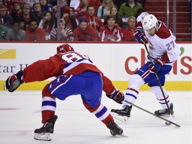 Washington Capitals defenseman Nate Schmidt (88) tries to get the puck away from Montreal Canadiens center Alex Galchenyuk (27) during the second period of an NHL hockey game, Saturday, Dec. 26, 2015, in Washington.