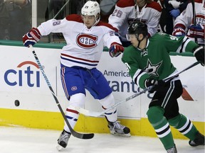 Montreal Canadiens defenceman Nathan Beaulieu and Dallas Stars centre Jason Spezza chase the puck during the first period of an NHL hockey game Saturday, Dec. 19, 2015, in Dallas.