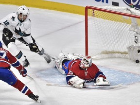San Jose Sharks' centre Patrick Marleau (12) scores the first goal on Montreal Canadiens' goalie Dustin Tokarski (35) as Montreal Canadiens' centre Alex Galchenyuk (27) moves in during first period NHL action, in Montreal, on Tuesday, Dec. 15, 2015.