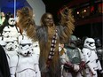 People dressed as characters from the film pose upon arrival at the European premiere of Star Wars: The Force Awakens in London, Dec. 16, 2015.