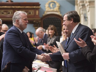Quebec Premier Philippe Couillard, left, congratulates Quebec Education Minister Francois Blais after he tabled legislation on school boards, Friday, December 4, 2015 at the legislature in Quebec City.