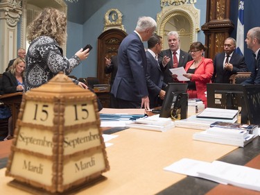 Quebec Premier Philippe Couillard, centre, speaks with aides and colleagues as the legislature resumes for its fall session, Tuesday, September 15, 2015 at the legislature in Quebec City.