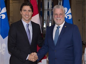Quebec Premier Philippe Couillard greets Prime Minister Justin Trudeau , left, at his Quebec City office, on Friday, Dec. 11, 2015. One of these men has already signed off on sinking  more than $1 billion of public money into Bombardier's CSeries jet program. Will the other follow suit?