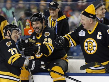 Former Boston Bruins' Ray Bourque (77) celebrates with teammates Jay Miller (29) and Terry O'Reilly after scoring in a shootout during an Alumni outdoor hockey game at Gillette Stadium against former players from the Montreal Canadiens in Foxborough, Mass., Thursday, Dec. 31, 2015, where the Bruins will play the Canadiens in the NHL Winter Classic on Friday. The Bruins won 5-4.
