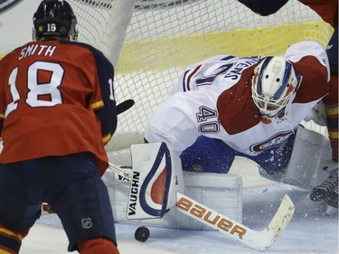 Montreal Canadiens goalie Ben Scrivens (40) makes a save on a goal attempt by Florida Panthers right wing Reilly Smith (18) during the third period of an NHL hockey game, Tuesday, Dec. 29, 2015, in Sunrise, Fla. The Panthers defeated the Canadiens 3-1.