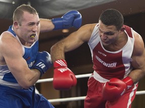 Samir El-Mais lands a right to the head of Paul Rasmussen on his way to a unanimous decision in their 91kg bout at the Canadian Olympic Boxing trials, in Montreal, on Thursday, Dec. 10, 2015.