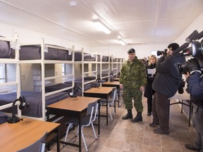 Col. Sebastien Bouchard guides reporters in a temporary barrack at the cadet summer camp transformed into lodging for Syrian refugees, Tuesday, December 8, 2015 at CFB Valcartier. CFB Valcartier could lodge over 2000 refugees within 48 hours.