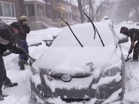 Mark Przybylowski and Paula Malolepszy drove around the west end of Montreal Tuesday, December 29, 2015 to help people shovel out their cars after the season's first heavy snowfall with the hope they can inspire other Montrealers to help their fellow citizens.