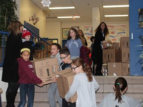 Students at St. George's Elementary School collected 65 large boxes of food for the Sun Youth Organization.