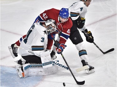 Montreal Canadiens' right wing Sven Andrighetto (42) tries to squeeze between San Jose Sharks' goalie Martin Jones (31) and San Jose Sharks' defenceman Brenden Dillon (4) during third period NHL hockey action, in Montreal, on Tuesday, Dec. 15, 2015.