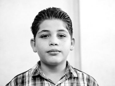 Syrian refugee Adnan, 9, from Kherbet Ghazala, Syria is seen Monday, November 30, 2015 in Irbid, Jordan. His family is waiting for final approval to immigrate to Canada.