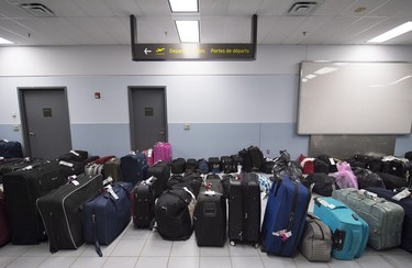 The luggage of newly-arrived Syrian refugees waits to be loaded at Pearson International airport, in Toronto, on Friday, Dec. 11, 2015.