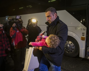 Syrian refugees arrive by bus to a hotel on Dixon Rd. near Toronto Pearson International Airport in Toronto, Ont.  on Friday December 11, 2015.