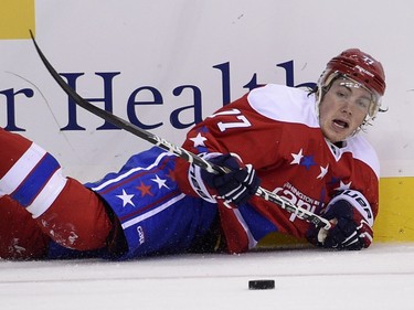 Washington Capitals right wing T.J. Oshie (77) and Montreal Canadiens right wing Dale Weise (22) chase the puck during the first period of an NHL hockey game Saturday, Dec. 26, 2015, in Washington.