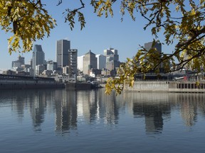 The City of Montreal is reflected in the St. Lawrence River, Tuesday, November 10, 2015. The city of Montreal will begin a massive sewage dump Wednesday for repairs to its sewage infrastructure, dumping 8 billion litres of untreated wastewater into the St. Lawrence over the space of a week.