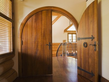 The half-moon door of the original master suite has a medieval design to it with elaborate wrought-iron hinges and bolts. (Photo by Perry Mastrovito)