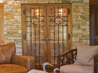 The wine cellar with controlled temperature and humidity is also clad in natural stones to match with the fireplace. (Photo by Perry Mastrovito)